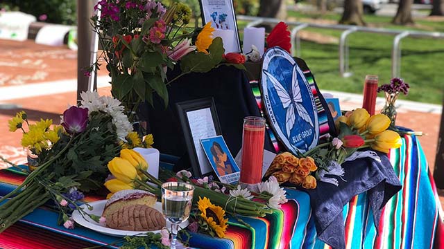 Table with colorful blanket, flowers and candles